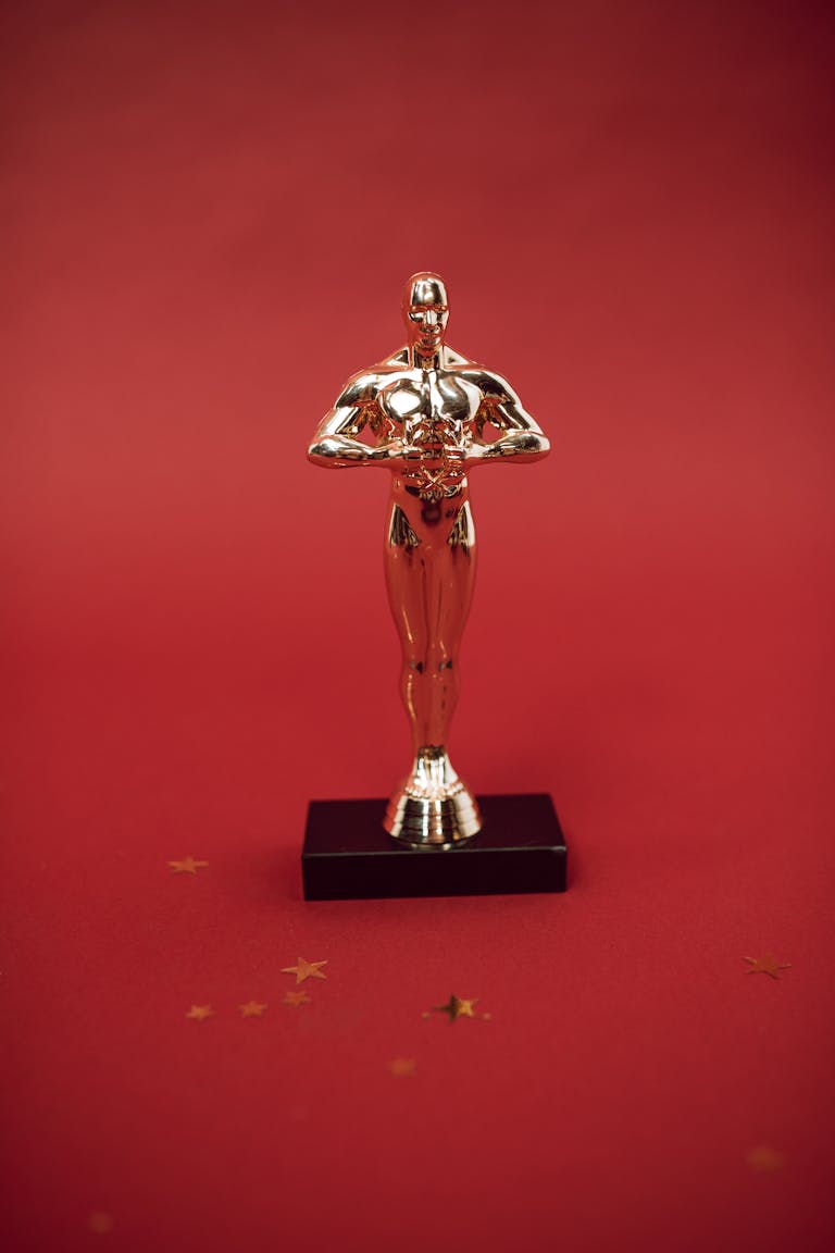 A shiny golden trophy standing against a vivid red backdrop, symbolizing achievement.